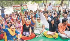  ??  ?? National Health Mission workers sitting on a dharna outside the civil surgeon’s office in Rohtak on Tuesday. MANOJ DHAKA/HT