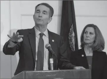  ?? The Associated Press ?? UNDER FIRE: Virginia Gov. Ralph Northam, left, gestures as his wife, Pam, listens during a news conference in the Governors Mansion at the Capitol in Richmond, Va., Saturday. Northam is under fire for a racial photo that appeared in his college yearbook.