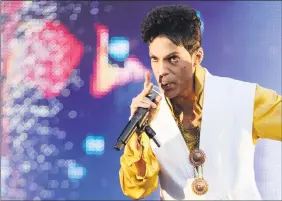  ??  ?? Prince performing on stage at the Stade de France in Saint-Denis, outside Paris, in 2011.