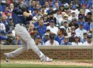  ??  ?? Milwaukee Brewers’ Christian Yelich (22) hits an RBI single during the third inning of a tiebreak baseball game against the Chicago Cubs on Monday, Oct. 1, 2018, in Chicago. (AP Photo/Matt Marton)