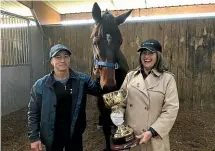  ??  ?? Lance O’Sullivan with Charles Road, the Melbourne Cup and Sheila Laxon who trained Ethereal to win the race in 2001.