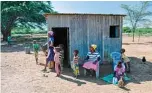  ??  ?? A family at the Salabani village that was forced from their homestead by the rising water levels in Lake Baringo are photograph­ed at their refuge.