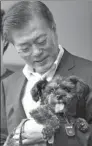  ?? BLUE HOUSE VIA REUTERS ?? ROK President Moon Jae-in welcomes a rescue dog to his residence in Seoul on Wednesday.