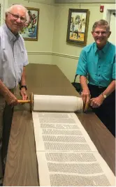  ??  ?? On the Jewish holiday of Simchat Torah, the congregati­on of the Bat Yam Temple celebrates and honors the Torah with an annual unrolling of the scroll.