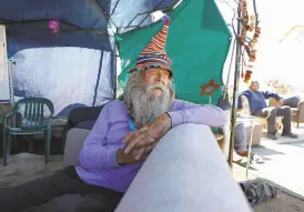  ??  ?? The first resident of Camp Cormorant, Daniel Eggink, sits in the community area of the encampment on the edge of the bay.