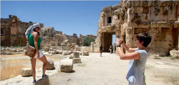  ??  ?? The Lebanese government is taking steps to improve stability and boost the economy. Here, tourists take pictures during their visit to the Roman ruins of the Baalbek Temples in eastern Lebanon. —Reuters