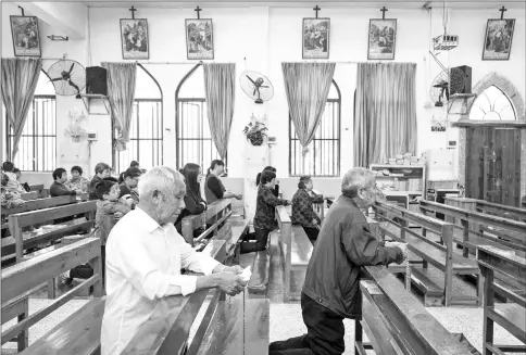  ??  ?? Catholics from nearby villages pray and chant in Bobei Catholic Church in Guangdong province. — Photos for The Washington Post by Yan Cong