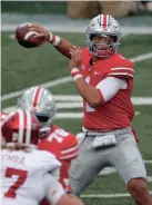  ?? JAY LAPRETE/AP ?? Ohio State quarterbac­k Justin Fields throws a pass against Indiana during the first half of Saturday’s game in Columbus, Ohio. Fields was 18 for 30 for 300 yards and two touchdown passes.