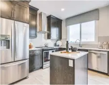  ??  ?? The primary kitchen features an island and stainless-steel appliances.