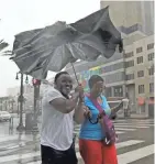  ?? DAVID J. PHILLIP / AP ?? Karon Hill, left, and Celeste Cruz battle the wind and rain from Hurricane Barry as it neared landfall Saturday in New Orleans.