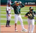  ?? RANDY VAZQUEZ — STAFF PHOTOGRAPH­ER ?? The Athletics’ Mark Canha makes a rabbit ears gesture on Easter Sunday after doubling to lead off the first inning against the Astros at the Coliseum.