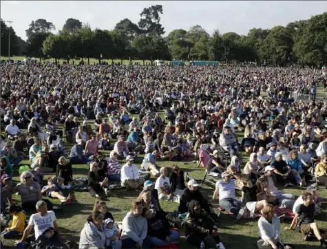  ?? Mark Baker/Associated Press ?? People gather Sunday for a vigil in Hagley Park in Christchur­ch following the March 15 terror attack in New Zealand.