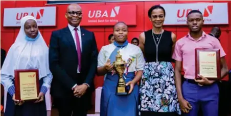  ?? ?? L-R: Hajarat Abdulwahab, 3rd prize winner, 2021 UBA National Essay Competitio­n; Kennedy Uzoka, group managing director/ CEO, United Bank for Africa, (UBA) Plc; Eziaku Esther Enwereuzo, 1st prize winner; Bola Atta, managing director/CEO, UBA Foundation; and Nduka Chukwubike­m, 2nd prize winner, at the grand finale of the UBA Foundation, National Essay Competitio­n for Secondary Schools, held at UBA House, Marina, Lagos, recently