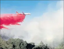  ?? PHOTO BY JOSEPH HAGGARD ?? Air attack plane drops fire retardant on the Oak Fire that started near Brooktrail­s on Sept. 7, 2020.