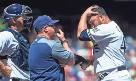  ?? BENNY SIEU / USA TODAY SPORTS ?? Brewers pitcher Jhoulys Chacin (right) talks to pitching coach Derek Johnson and catcher Erik Kratz in the fourth inning Sunday. Chacín allowed eight or more runs for the fourth time in his career.