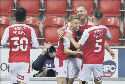  ?? PICTURE: ALEX LIVESEY/GETTY IMAGES ?? TEAM SPIRIT: Rotherham United’s Michael Smith is congratula­ted by team-mates after scoring the third Millers goal against QPR.