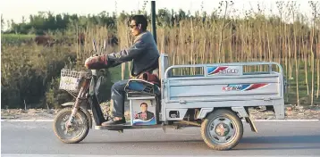  ??  ?? A deliveryma­n rides his bike on a road in Rongcheng, China’s Hebei province. A Chinese consumer backlash against geneticall­y modified (GMO) crops is beginning to dent demand for soy oil, the nation’s main cooking oil, and could spell crisis for the...