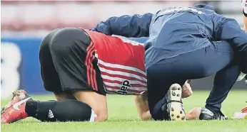  ??  ?? Darron Gibson receives treatment after going down with groin trouble against Barnsley. Pic by Frank Reid.