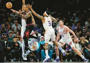  ?? MATT YORK/AP PHOTOS ?? Bulls forward DeMar DeRozan passes as Phoenix Suns guard Bradley Beal (3) defends during the first half on Monday.