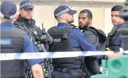  ?? Dominic Lipinski ?? > Armed police at the scene after a man was arrested following yesterday’s incident in Whitehall