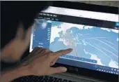  ?? ERDEM SAHIN/EPA ?? An engineer checks a map of a cyberattac­k threat Tuesday in Turkey. The attack may be tied to leaked NSA code.