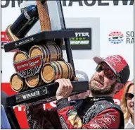  ?? AP/BEN MARGOT ?? Martin Truex Jr. lifts the trophy after winning last week’s NASCAR Monster Energy Cup Series race at Sonoma, Calif. He will start 12th in today’s race at Chicagolan­d Speedway in Joliet, Ill.