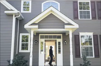  ?? JOHN MINCHILLO — THE ASSOCIATED PRESS FILE ?? Anil Lilly tours his new home, in Washington­ville, N.Y. The coronaviru­s pandemic helped shape the housing market by influencin­g everything from the direction of mortgage rates to the inventory of homes on the market to the types of homes in demand and the desired locations.