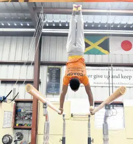  ?? ?? Coach Daniel Williams demonstrat­es some moves on the parallel bars.