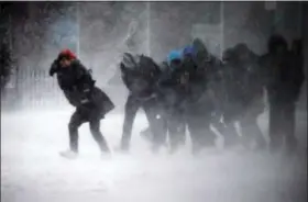  ?? MICHAEL DWYER — THE ASSOCIATED PRESS ?? People struggle to walk in the blowing snow during a winter storm Tuesday in Boston.