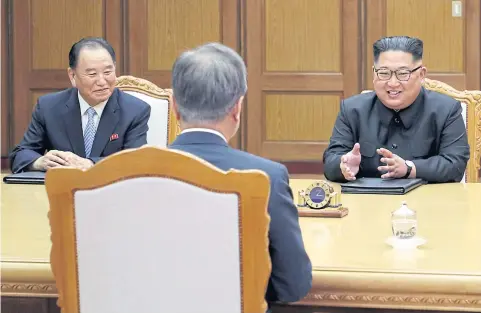  ?? REUTERS ?? North Korean leader Kim Jong-un talks with South Korean President Moon Jae-in as Kim Yong-chol, vice chairman of the Central Committee of the Workers, listens.