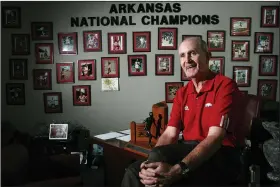  ?? (Democrat-Gazette file photo) ?? John McDonnell sits in his office at Bud Walton Arena in Fayettevil­le in 2008 with one of his conference championsh­ip trophies. He won 84 of them during his tenure at the University of Arkansas.