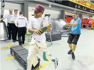  ?? Picture: GETTY IMAGES/ CLIVE MASON ?? EXCITED: Race winner Lewis Hamilton of Mercedes GP celebrates with his team after his victory in the Formula One Grand Prix of Singapore at Marina Bay Street Circuit on Sunday.