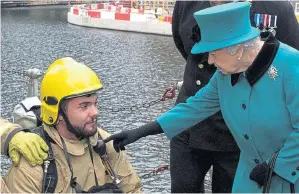  ??  ?? To the point... the Queen meets ship firefighte­r Stanley Money, 21, yesterday