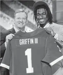  ?? Jason DeCrow / Associated Press ?? Robert Griffin III, right, was the second selection in the 2012 draft. Injuries have cost Griffin, who did not play last season.