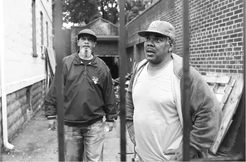  ??  ?? Penn, left, who is seeking a job in constructi­on, and Price, a constructi­on worker, talk about their Jersey City neighbourh­ood.