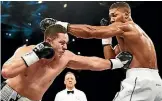  ?? PHOTOSPORT ?? Joseph Parker lands a jab on Anthony Joshua during their world heavyweigh­t title fight.