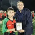  ??  ?? Brendan Lawrence presents Christy Mooney of St Kevin’s with the Wicklow People sponsored Man of the Match award.