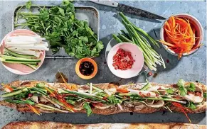  ??  ?? Adam Liaw’s mega banh mi is drizzled with seasoning before serving.