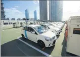  ?? PROVIDED TO CHINA DAILY ?? Electric cars are parked at a charging station business district of Beijing. in the central