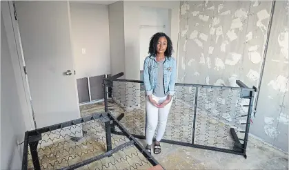  ?? DAVID BEBEE WATERLOO REGION RECORD ?? University of Waterloo student Lang Ncube stands in the partly repaired, water-damaged bedroom of her rental apartment.