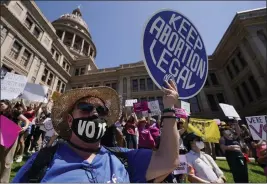  ?? PHOTOS BY ERIC GAY — THE ASSOCIATED PRESS FILE ?? Abortion rights demonstrat­ors attend a rally at the Texas state Capitol in Austin, Texas, on May 14, 2022. On Monday, five women sued Texas over its abortion ban — saying they were denied abortions even when pregnancy endangered their lives.