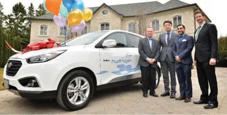  ?? HYUNDAI ?? The delivery of the first Hyundai Tucson FCEV in Ontario. The keys to the fuel-cell crossover were handed to Joseph Cargnelli, left, co-founder of Hydrogenic­s Corporatio­n on March 10 by Hyundai dealership representa­tives from Don Valley North Hyundai.