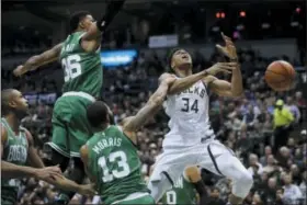  ?? MORRY GASH — THE ASSOCIATED PRESS ?? Milwaukee Bucks’ Giannis Antetokoun­mpo is fouled during the first half of Game 6 of an NBA basketball first-round playoff series against the Boston Celtics Thursday in Milwaukee.