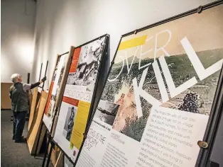  ?? GABRIELA CAMPOS/THE NEW MEXICAN ?? Ruth Sabiers helps assemble panels Thursday for the My Lai Massacre Memorial Project at El Museo Cultural de Santa Fe. The three-day show on the slaughter of civilians by American soldiers during the height of the Vietnam War opens Friday.