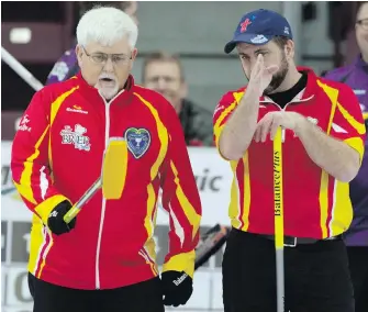  ?? MICHAEL BURNS, THE CANADIAN PRESS ?? Team Nunavut skip Jim Nix, left, and third Edmund MacDonald discuss their options during their Brier pre-qualifying match in St. John’s on Friday.