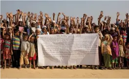  ?? — AP ?? Rohingya children and refugees raise their hands and shout that they won’t go back to Myanmar during a demonstrat­ion at Kutupalong near Cox’s Bazar, Bangladesh, on Monday.