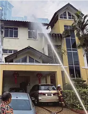 ?? (Foto ihsan Bomba Kuala Lumpur) ?? Anggota bomba memadamkan kebakaran banglo tiga tingkat di Taman Gembira, Seputih, Kuala Lumpur, semalam.