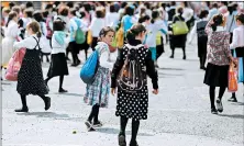  ?? MIKE GROLL/AP 2014 ?? Two girls leave day camp in New York’s Orange County. Such suburban camps fill up with kids from Orthodox Jewish communitie­s hit hardest by a measles outbreak this year.