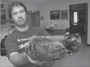  ??  ?? Simon Fraser University biology grad student Michael Beakes is seen earlier this year with a snakehead fish caught in a lagoon at Burnaby’s Central Park. It’s known as the ‘ fish from hell.’