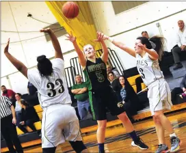  ?? Photo by Louriann Mardo-Zayat |lmzartwork­s.com ?? North Smithfield junior forward Rachel Ferland (5) shoots over two Davies Tech defenders during second-half action Thursday night.